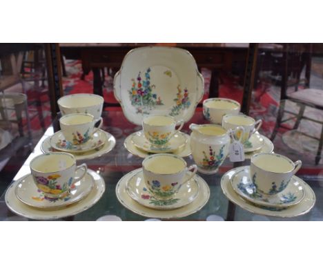 An Art Deco Crown Staffordshire Pan design part tea set, for six, printed and painted in bright enamels with assorted spring 