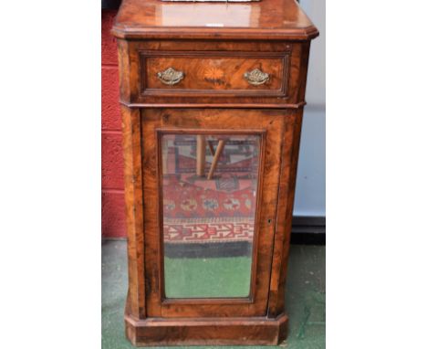 An early 20th century walnut and mahogany music cabinet, slightly oversailing chamfered rectangular top above a frieze drawer