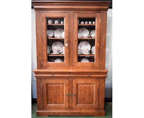 A substantial 20th century oak bookcase, outswept cornice above a pair of glazed doors enclosing three adjustable shelves, th
