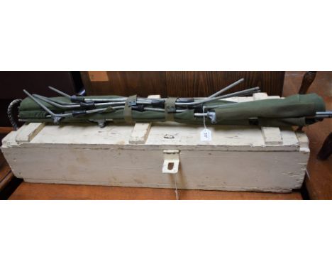 A painted pine ammunition box, rope carry handles, a green canvas camp/cot bed, c.1970's (2)
