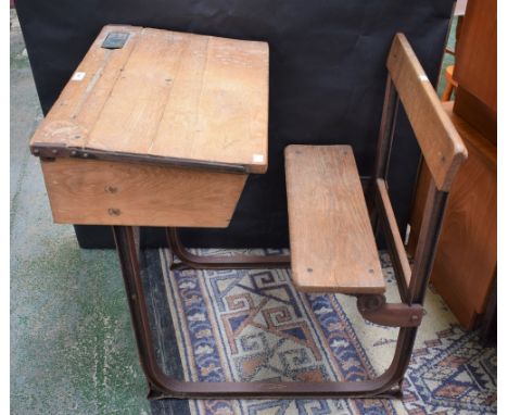 An early 20th century pine school desk, cast metal frame, bench en suite