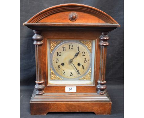 An early 20th century mahogany arch top architectural mantel clock, eight day movement, Arabic numerals on silvered dial, 36.