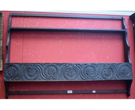 A carved oak wall hanging shelf/plate rack, 125cm wide