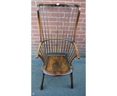 A 19th century elm wingback Windsor elbow chair, or unusual proportions, saddle seat, shallow ring turned spreading legs, H-s