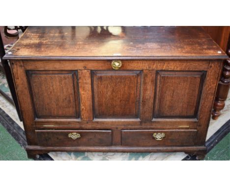 A late 18th/early 19th century oak blanket chest, moulded hinged rectangular top above a three panel fall front enclosing a p