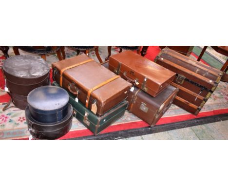 A 20th century dome-topped travelling trunk; another, rectangular; suitcases; hat boxes (9)