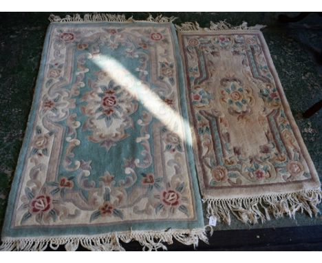 A Chinese woven wool carpet, stylised flowers of cream, pink, green and mink on a pale green ground, 150cm x 90cm; another si