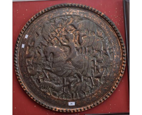 A Persian style copper charger embossed in low relief with an image of The Shah hunting, 68cm diameter, c.1900