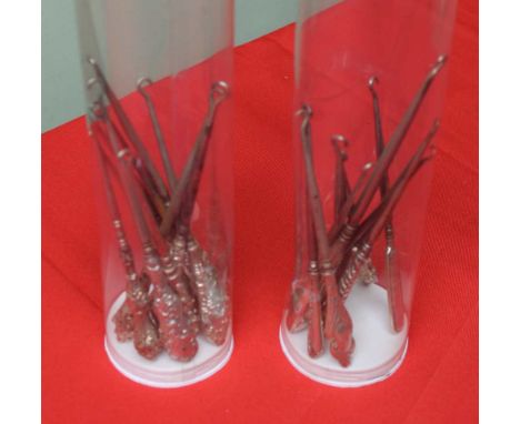 A collection of button hooks, includes hallmarked silver, in two plastic tubes