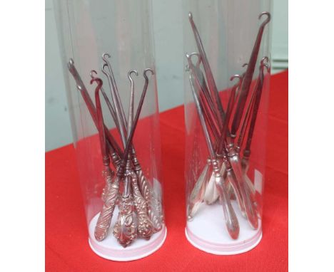 A collection of button hooks, includes hallmarked silver, in two plastic tubes