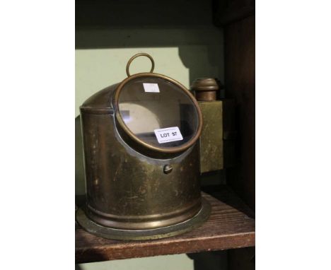 A vintage brass ships compass with side burner to light the instrument