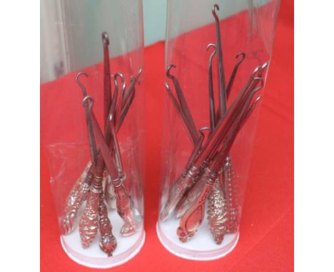 A collection of button hooks, includes hallmarked silver, in two plastic tubes