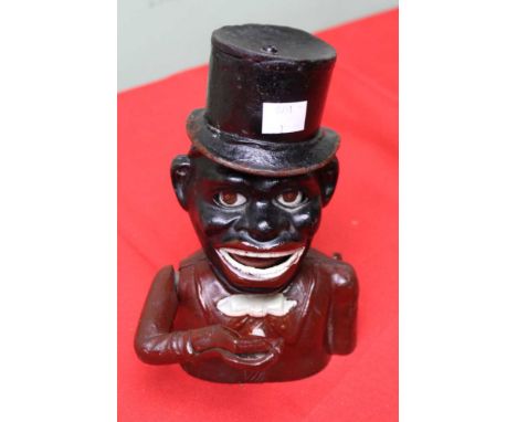 A cast iron money bank, painted decoration, having articulated right arm  These items are listed on the basis they are illust