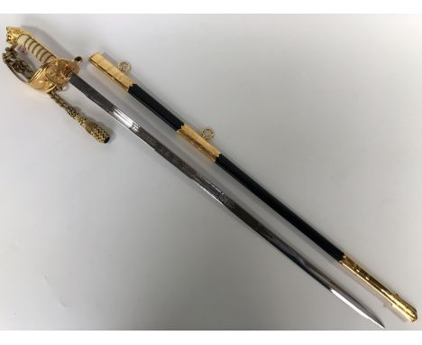 A QEII Royal Navy officer's sword by Wilkinson Sword, the hilt's folding guard bearing the initials of Britannia Royal Naval 