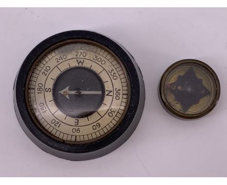 A Second World War British military escape and evasion miniature compass, together with a small Bakelite compass