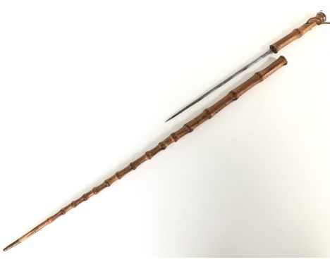 A Victorian white-metal mounted bamboo sward / dagger stick, having a fullered triangular-section blade, the hilt having a do