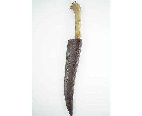 An antique Indo-Persian kard, of diminutive stature, the grip having jade scales, the blade exhibiting traces of Damascening,