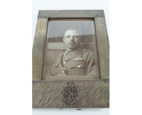 A Great War Arts and Crafts influenced electroplate photograph frame bearing an applied Royal Flying Corps officer's collar b