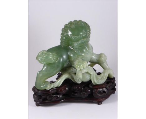 CHINESE JADE (POSSIBLY JADEITE) DOG OF FO FIGURE ON A HARDWOOD BASE