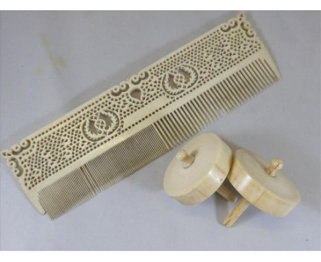 2 IVORY SPINNING TOPS AND A CARVED IVORY COMB