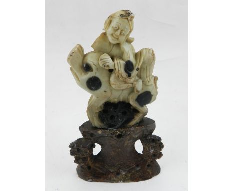 A Chinese cloisonne figure of Shao Lau holding a peach and stick, together with a soapstone figure riding a mythical horse, t