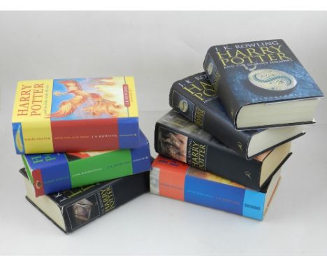 Seven Harry Potter books, mostly first edition