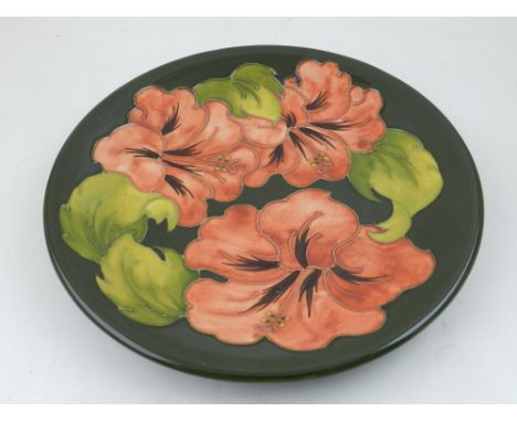 Moorcroft, England. A Coral Hibiscus design plate, circa 1960's D 26cm