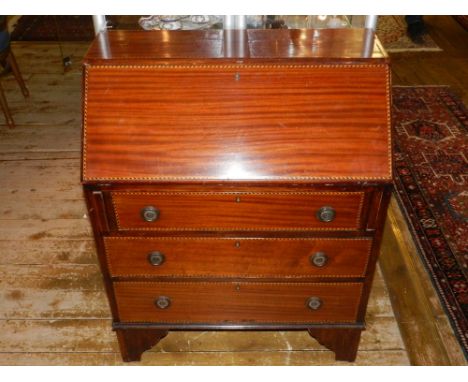 An Edwardian mahogany bureau with chequer banding, the fall enclosing a fitted interior above three drawers, on bracket feet,