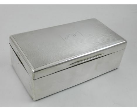 A hinged silver cigarette box, with wooden interior and gilt washed top, partially with engine turned design to exterior, ind