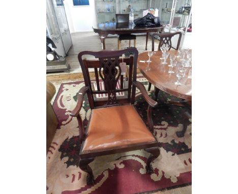 A set of five mahogany Chippendale style dining chairs, including one with arms, with pierced vase shaped splat and slip-in s