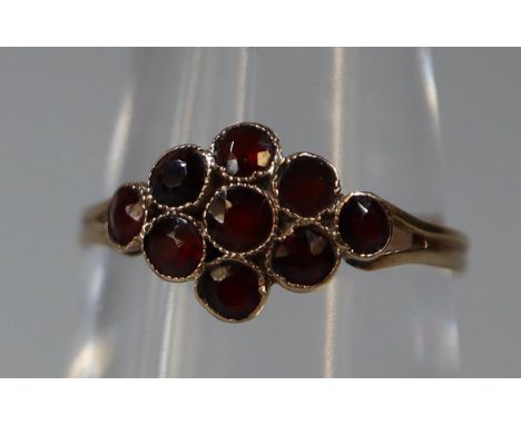 9ct gold and garnet cluster ring. Ring size M. Approx weight 1.1 grams. (B.P. 21% + VAT) One garnet appears to be set upside 