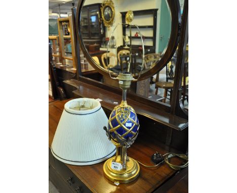 Modern gilt metal table lamp with shade, the base decorated with an egg and birds on circular stepped base. (B.P. 21% + VAT) 