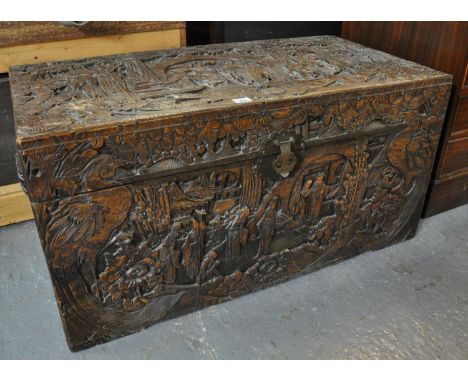 Chinese camphor wood chest or trunk deeply carved with immortals amongst pagodas and foliage with dragons. (B.P. 21% + VAT) O