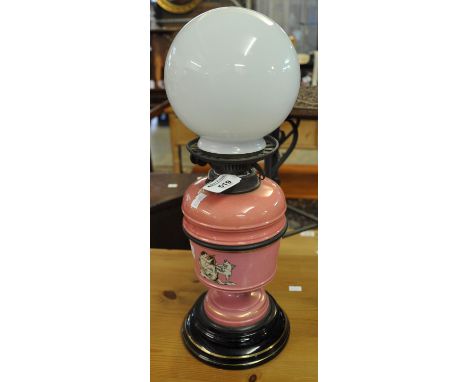 19th Century double burner oil lamp with ceramic reservoir and body on a black base with associated opaline glass shade. (B.P