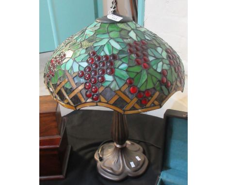 Tiffany style table lamp with berry and foliate decoration.(B.P. 21% + VAT) Shade is badly broken with pieces missing.