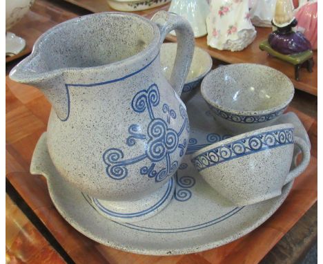 Mid Century stoneware set of four cups, a jug and a stand with blue stylised decoration, marked to base 'Roscoff'. (B.P. 21% 