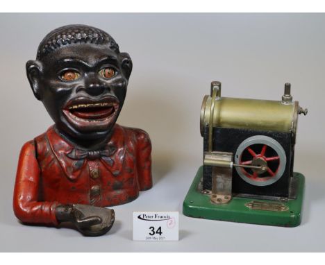 Cast iron black man money box, together with a tin plate 'Model Junior' steam engine. (2)(B.P. 21% + VAT) 
