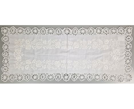 ˑ A white cotton table runner which was previously owned by Freddie Mercury. It features a floral embroidery design with cut 
