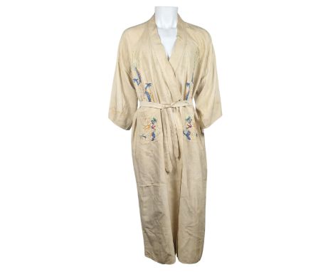 ˑ A cream robe which was previously owned by Freddie Mercury. The front and back panels feature dragons embroidered in yellow