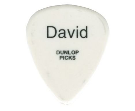 A white Dunlop guitar plectrum which was used on stage by David Bowie during a performance at the Scottish Exhibition and Con