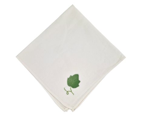 ˑ A white cotton napkin which was previously owned by Freddie Mercury. It features a leaf applique in one corner.
The napkin 
