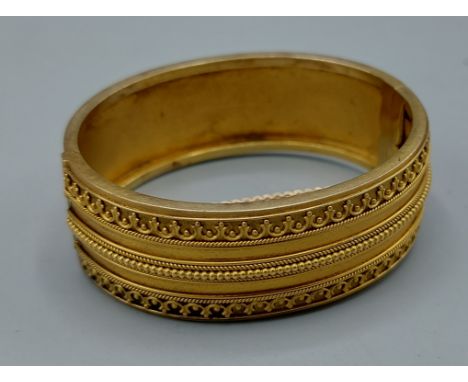 An Edwardian gold bangle, tested, 32gms 