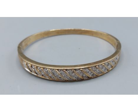 A 9ct gold bangle set with Diamonds, 14.9gms 