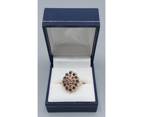 A 9ct gold cluster ring set with a central Emerald surrounded by Rubies and Sapphires, 3.7gms, ring size O 