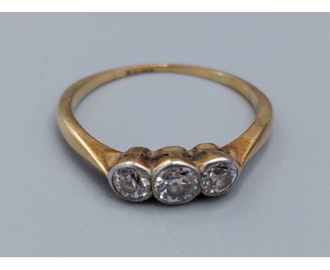 A yellow metal three stone Diamond ring, 2.1gms, ring size M 