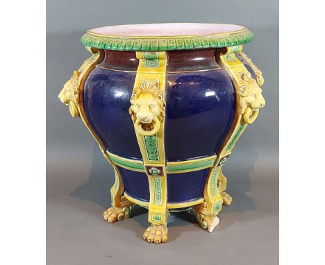 A Minton Majolica jardiniere with lion mask ring handles upon a Cobalt blue ground, 28cms tall 