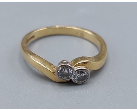 An 18ct gold Diamond crossover ring, set with two Diamonds, 3.3gms, ring size L 