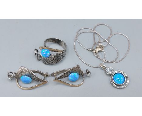 A 925 silver suite of jewellery, comprising of a ring, a pendant and chain and a pair of earrings all with engraved decoratio