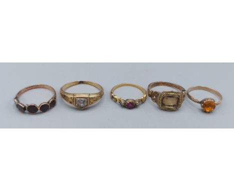 A 19th Century unmarked mourning ring, together with four other unmarked rings, 8.5gms 