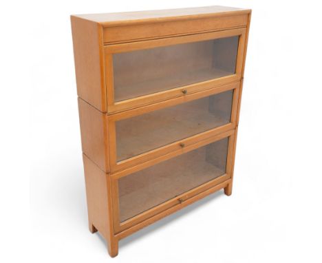 Angus Gunn - early 20th century light oak three sectional stacking bookcase, enclosed by hinged and sliding glazed doorsDimen